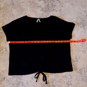 Black short sleeve top with cinch front tie.